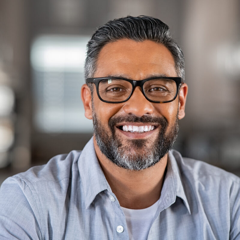 Smiling,Mature,Indian,Man,Wearing,Spectacles,And,Looking,At,Camera.