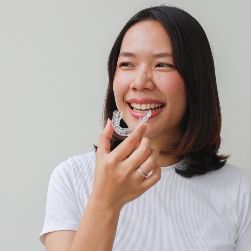 Close,Up,Young,Lovely,Asian,Woman,Hand,Holding,Dental,Aligner